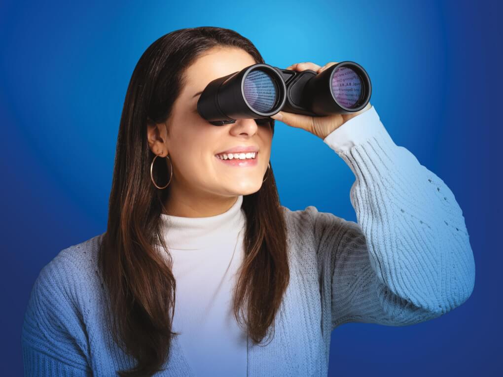 Woman looking through binoculars, course selections reflected in the lens